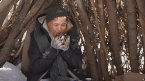 homeless girl drinks hot tea on the street. High quality Full HD video recording