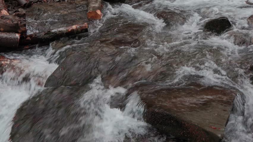 The water flows beautifully over the rocks. Mountain river. Beautiful little waterfalls. Beautiful streams and small waterfalls near the big Carpathian waterfall Shypit.