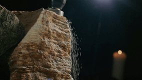 Stone cutting art. Media. Isolated on a dark background. The hands of the master with a power tool with a cutter are processing the sculpture - Powered by Shutterstock - Get 15% off with code: PIKWIZARD15