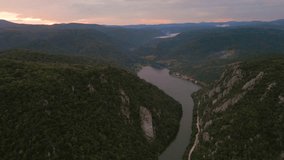 Drone video of the Danube gorge on Romanian side with the statue of king Decebalus in the view. Video was shot at a higher altitude in the summer at sunset.	
