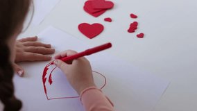 Little girl drawing red heart at white paper within red pens and pencils - Powered by Shutterstock - Get 15% off with code: PIKWIZARD15