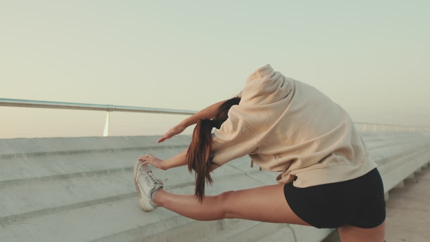 girl in sportswear doing workout, stretching at morning time