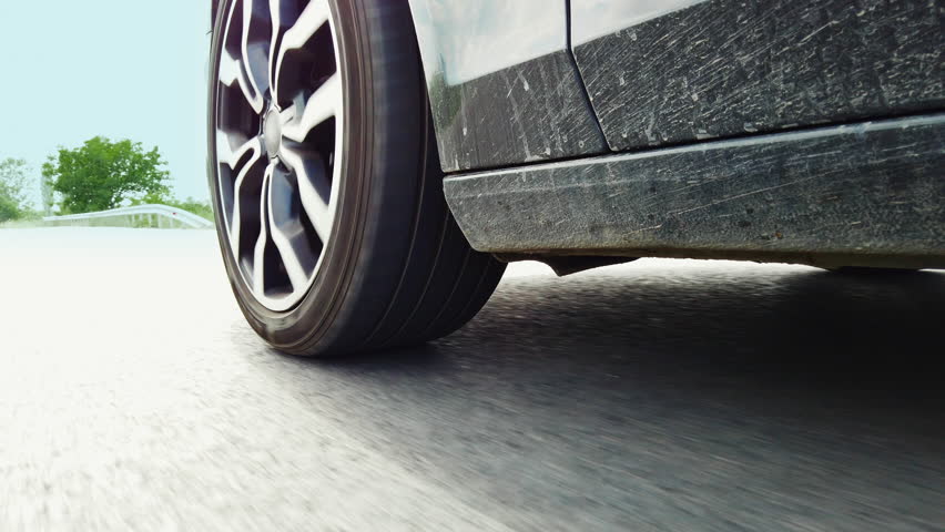 Car wheels, tires close up on a background of asphalt speeding on the highway | Shutterstock HD Video #1099178617