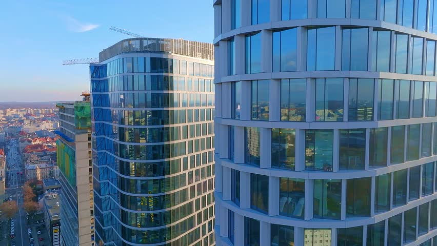 Drone view of a big city with skyscrapers. The concept of a modern city, large urban development. Tall buildings in the city, urban planning. Close up of glass skyscrapers. | Shutterstock HD Video #1099183645