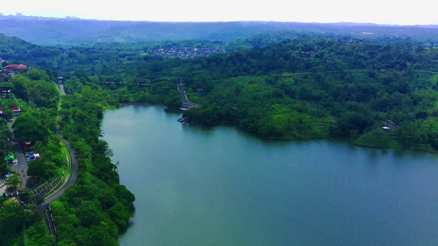 Aerial flyover the Jatibarang reservoir dam in Semarang. Central Java. Indonesia. Drone footage.