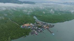 Top down aerial view of fishing harbour,fisherman village with jettys,Drone camera flying over foggy in the morning, High angle view video