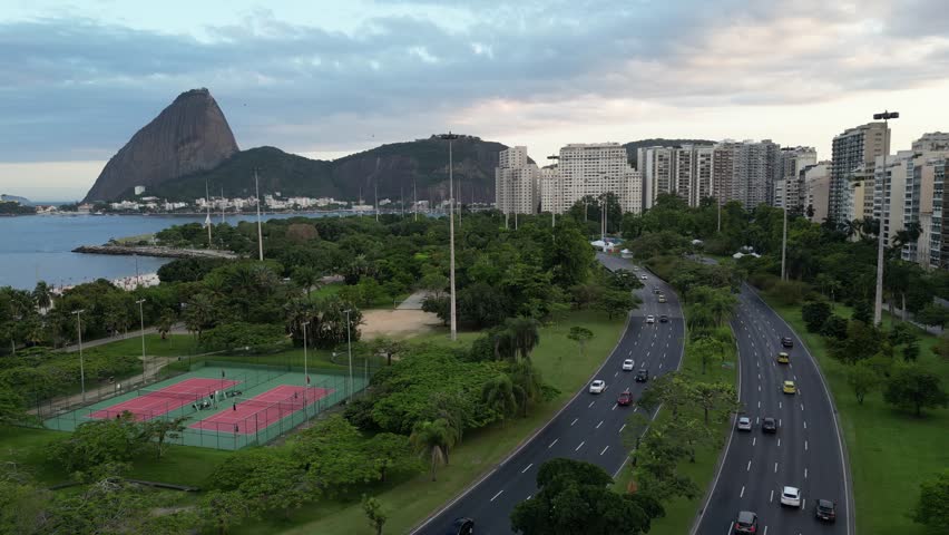 Beautiful view to green leisure area, city buildings, ocean and mountains in Rio de Janeiro, Brazil