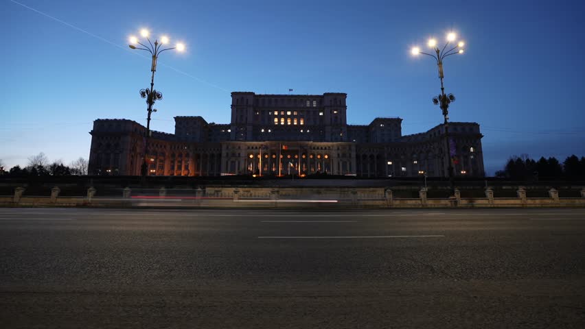 Night blue hour traffic 4K time lapse video in Bucharest, with Palace of the Parliament (Casa Poporului in Romanian language) landmark building from Romania. Travel to Bucharest.