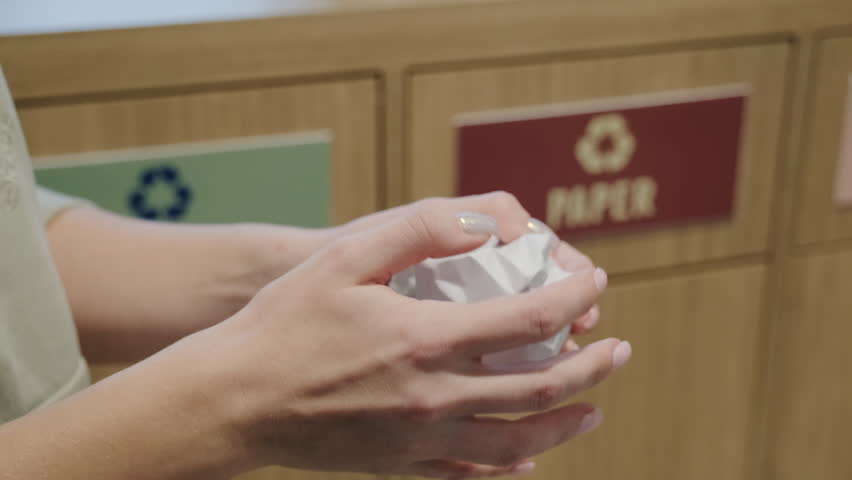 Womans hand crumple, crush sheet of paper ball and throw it in a recycling bin. Concept of waste sorting, reuse, separate litter disposal. Take out garbage into the paper rubbish box. | Shutterstock HD Video #1099191107