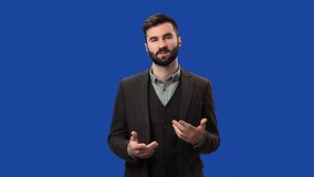 Man business blogger vlogger TV news leading anchorman in suit talking smiling isolated blue screen chroma key background. Male influencer television channel webinar show auditorium communication 