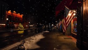 Snow falling outside of small town store in America. American flags hang on sidewalk while snow falls in December on main street of Wellsboro PA. Beautiful American white Christmas theme. - Powered by Shutterstock - Get 15% off with code: PIKWIZARD15