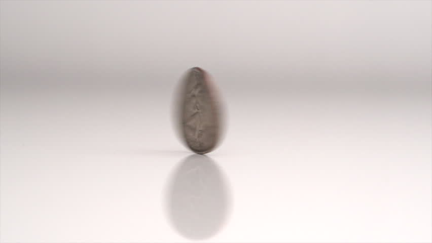 Quarter Spinning On Table In Slow Motion