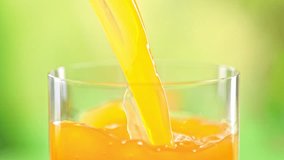 Super Slow Motion Detail Shot of Pouring Fresh Orange Juice into Glass at 1000 fps. - Powered by Shutterstock - Get 15% off with code: PIKWIZARD15