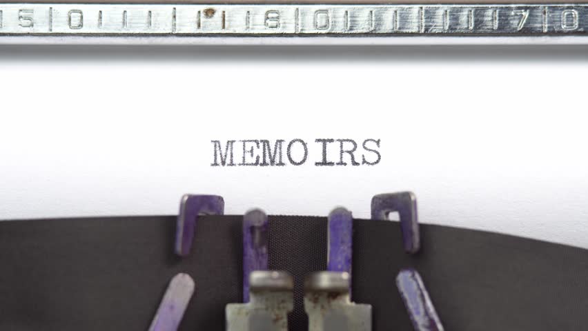 Memoirs word closeup being typing and centered on a sheet of paper on old vintage typewriter mechanical