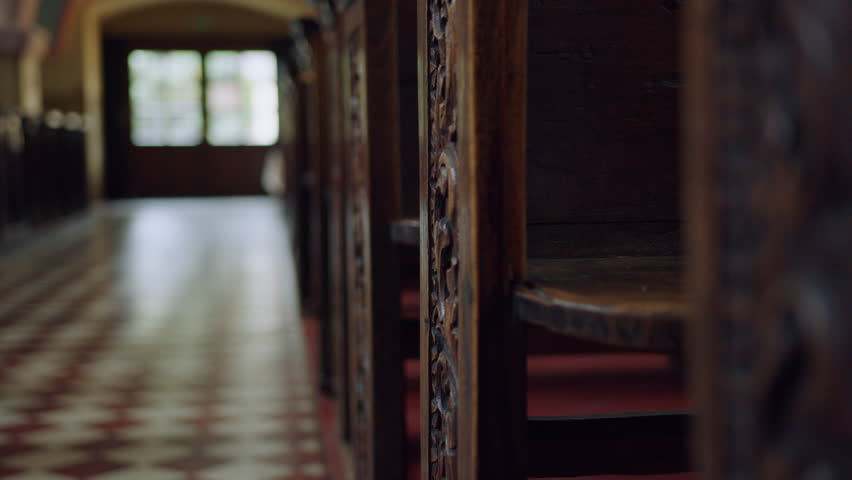 The interior of the Catholic church. Wooden church pews. Prayer