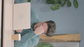 Vertical Video of Mature Adult Man having Headache while Working on Laptop - Powered by Shutterstock - Get 15% off with code: PIKWIZARD15