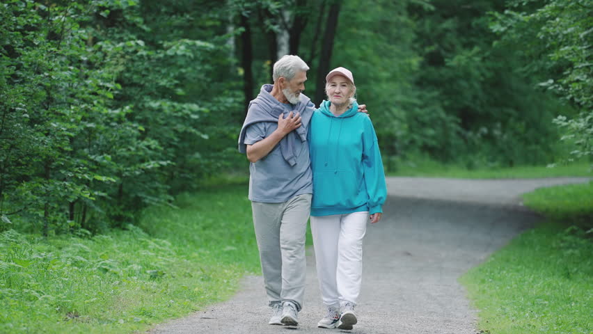 Couple old loving people walk nature forest park. Cute senior grandparents enjoy talk. Happy elder family stroll close up. Old pensioners pair date green wood. Elderly romantic husband person hug wife Royalty-Free Stock Footage #1099207881
