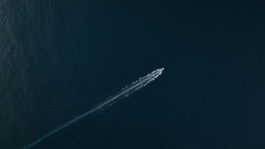 Sports boat sails in the mediterranean sea, top view, blue sea vertical view, perfect background