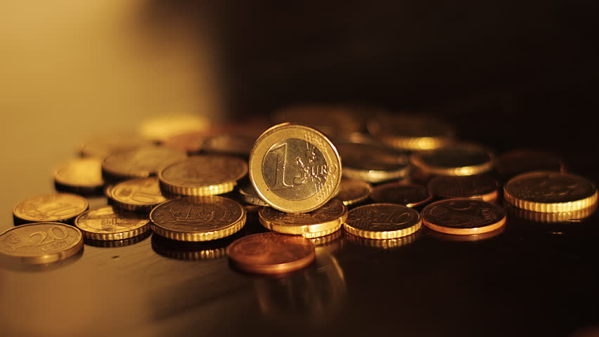 A euro coin falls from the push of a hand. Falling euro down. Currency depreciation Royalty-Free Stock Footage #1099217533