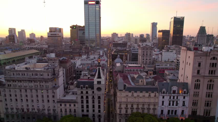 Aerial shot of an epic sunset of the city of Buenos Aires, old and new architecture of the downtown area. Illuminated streets