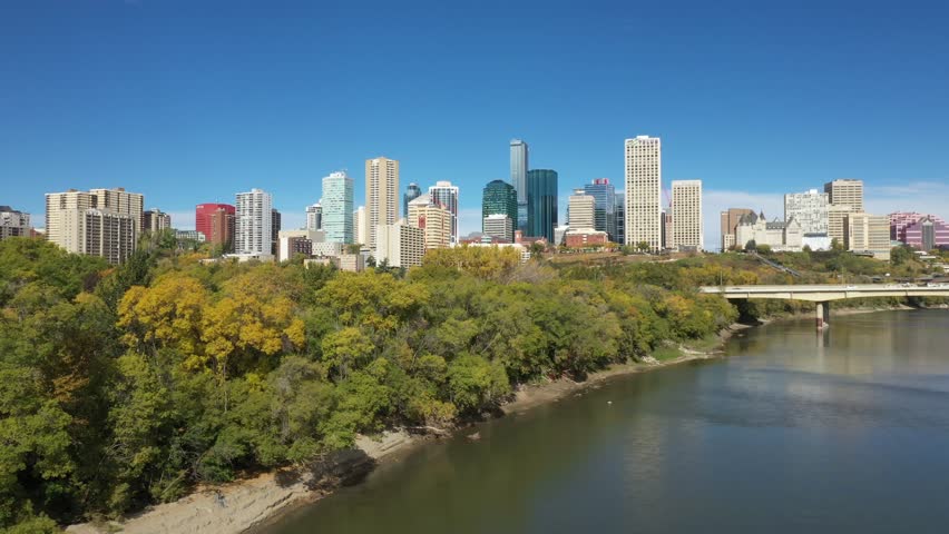Aerial drone view of the North Saskatchewan River and downtown Edmonton during autumn fall as seen from the Rossdale area. The James Macdonald Bridge is also featured.