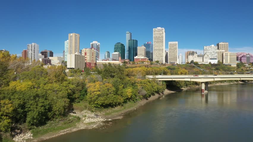 Aerial drone view of the North Saskatchewan River and downtown Edmonton during autumn fall as seen from the Rossdale area. The James Macdonald Bridge is also featured.