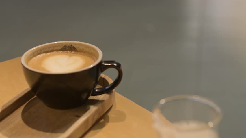 Cup of art latte or cappuccino coffee. | Shutterstock HD Video #1099238585