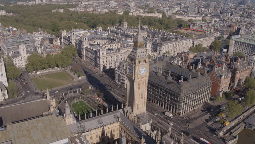 Aerial drone shot of Big Ben and Westminster Abbey with London in background on bright clear sunny day Royalty-Free Stock Footage #1099238751