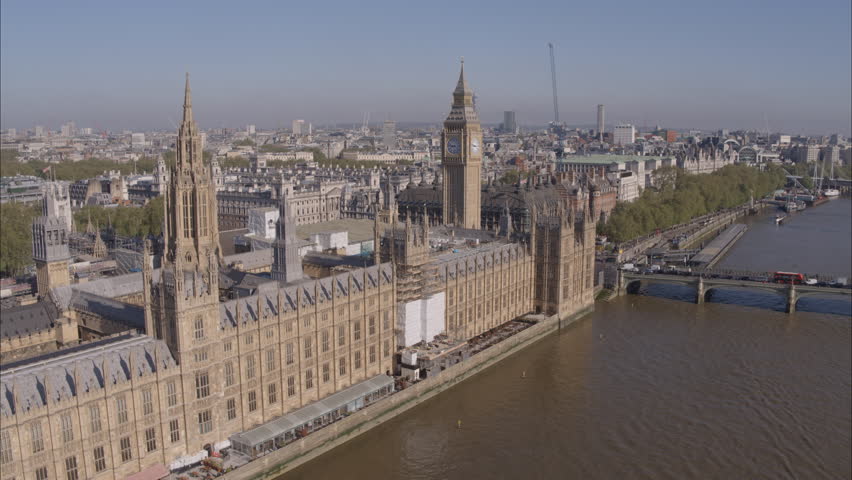 Aerial drone shot of Westminster Abbey and Big Ben over the River Thames on a bright clear sunny day