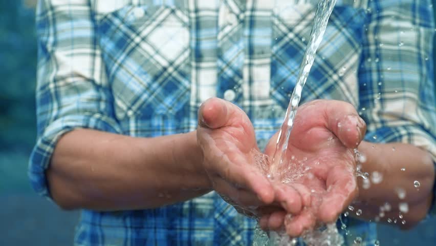 Spray and splashing of fresh water on the hands of a poor common man. the problem of drought on the planet. lifestyle farmer washes his hands after a hard day's work | Shutterstock HD Video #1099240221