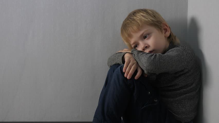 Domestic violence concept. sad upset boy sitting in corner. Child punished sitting crying in lifestyle the corner. Child abuse Royalty-Free Stock Footage #1099240235