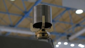 Pick and place industrial robotic clamp arm manipulator moving cylindrical metal workpiece at modern robot exhibition, trade show - close up view. Manufacturing, engineering, ai, technology concept - Powered by Shutterstock - Get 15% off with code: PIKWIZARD15