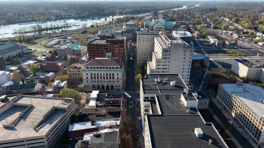 Downtown Trenton New Jersey. Aerial flight about city skyscrapers with view of Delaware River in autumn.