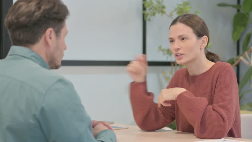 Young Woman Talking to Male Partner in Office | Shutterstock HD Video #1099246653