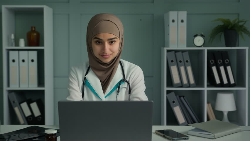 Glad happy arabian middle-eastern doctor young islamic religion woman practitioner therapist cardiologist dentist medical worker in white coat recommend good healthcare service make ok hand gesture Royalty-Free Stock Footage #1099249885
