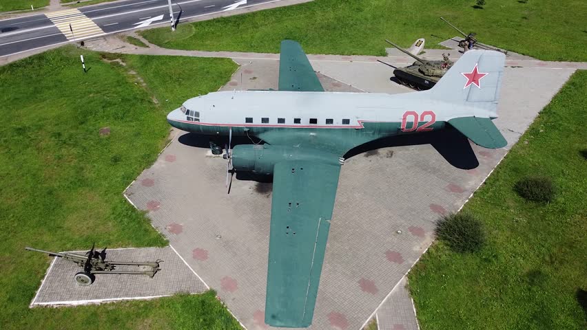 Aircraft fighter Douglas DC-3 Airplane in camouflage paint, museum of military equipment in summer park
