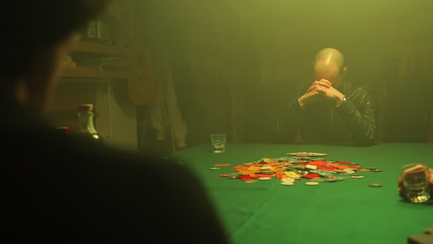 An excited poker player wins the game, reveals his cards and takes all the poker chips scattered on the table. Winning in gambling. Royalty-Free Stock Footage #1099250971