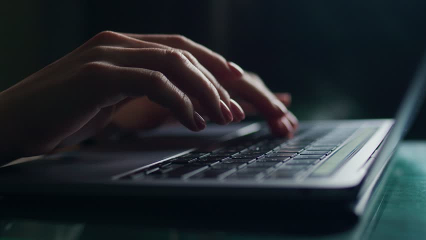 Female hands write text messages on a laptop keyboard close-up. Busy business woman emailing a client using a digital wireless handheld device remotely. Software, online education, apps, concept Royalty-Free Stock Footage #1099251945