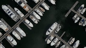 This 4K aerial video offers a unique straight-down view of boats floating on the water. The footage showcases the boats' design, colors and size. 