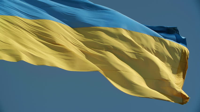 Ukrainian flag as a symbol of independence and unity in blue sunny sky. High quality 4k footage. Ukrainian flag fluttering in the wind. Peaceful Ukrainian blue sky. No war in Ukraine.  Royalty-Free Stock Footage #1099256503