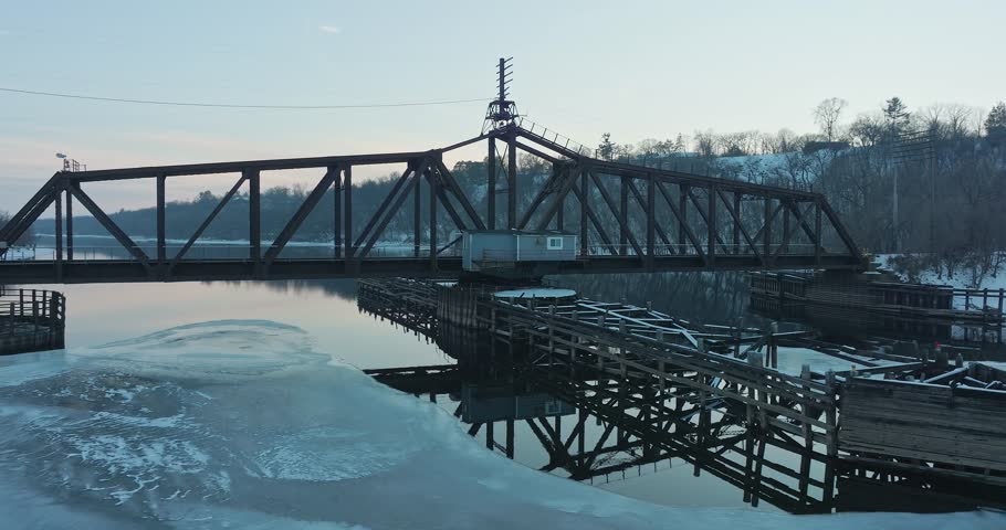 Railroad Bridge On Frozen St. Croix River In Hudson WI - Rotating Aerial View 1