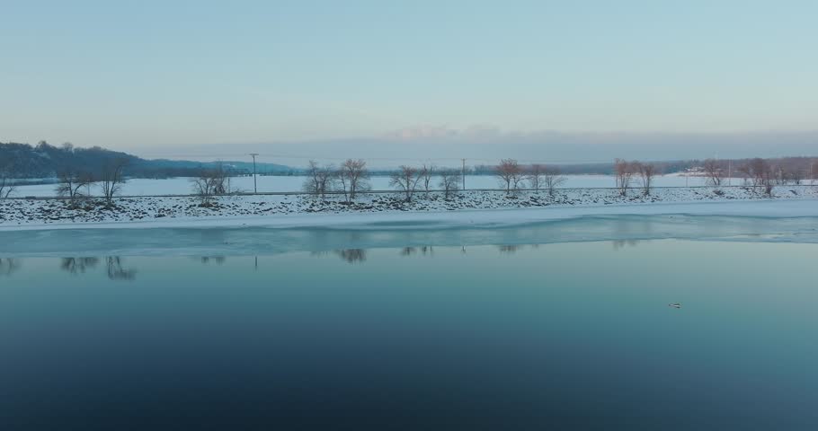 Person Walking Down Hudson Dike In Winter In Hudson WI - Drone Shot