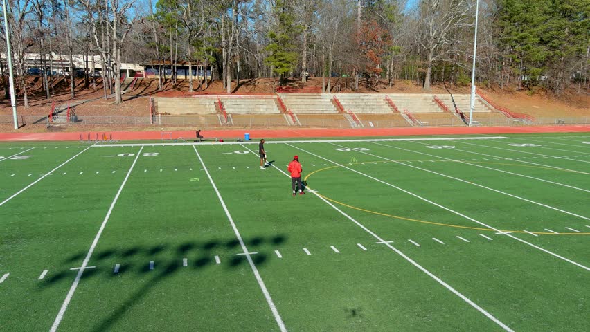 aerial footage of African American men doing football drills in the park in Atlanta Georgia USA