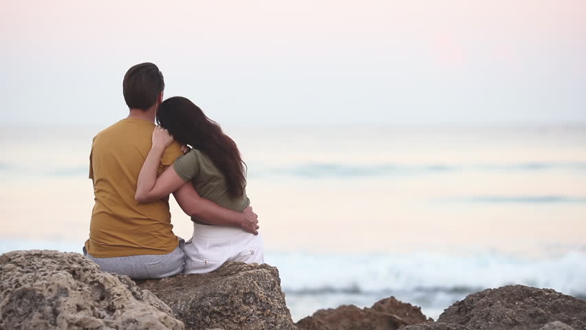Young couple spending time together on the beach | Shutterstock HD Video #1099261471