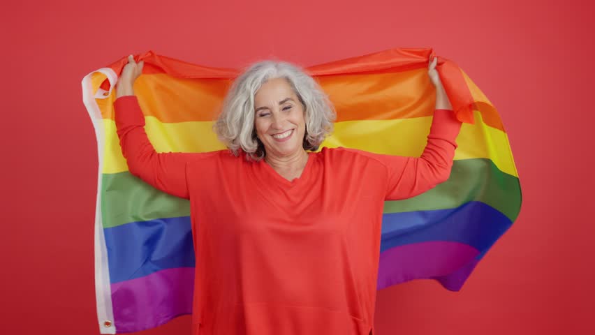 Mature woman wrapped with a lgbt flag | Shutterstock HD Video #1099262983