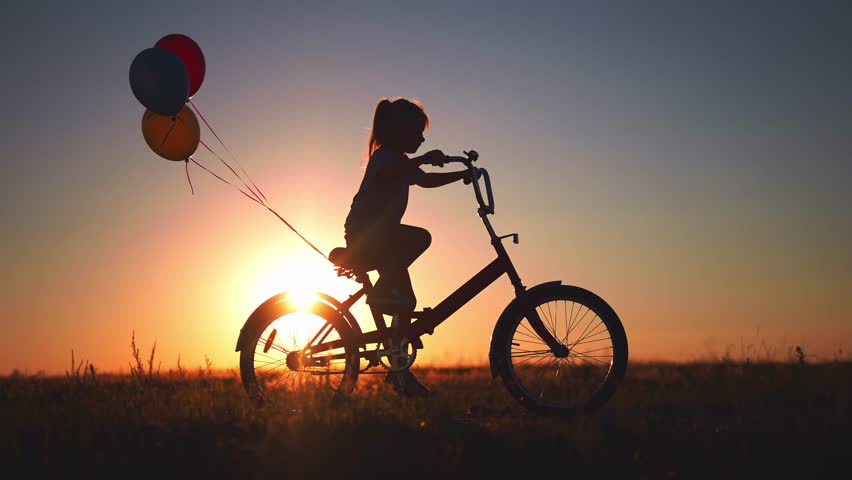 Girl kid silhouette bike riding on a park. kid girl rides a bike in nature in the park on the road. happy family kid dream concept. daughter plays a bike rides on a lifestyle sandy road | Shutterstock HD Video #1099269075