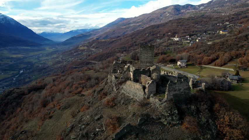 Medieval impressive castle Cly surrouded by Alps mountains in Valle d'aosta, aerial drone view