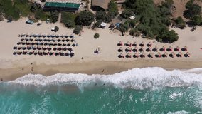 Aerial drone video of famous bay and organised sandy beach of Livadi Armenistis, popular for surfing sports, Ikaria island, Northeast Aegean, Greece