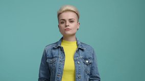 Beautiful girl with blonde hair holding a paper with job word. Portrait of cute woman looking for the vacancy. High quality 4k footage