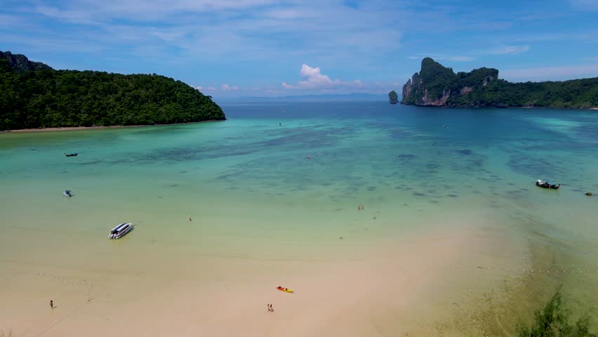 View of the turqouse colored ocean with longtail boats at Koh Phi Phi Don Thailand.  | Shutterstock HD Video #1099290293